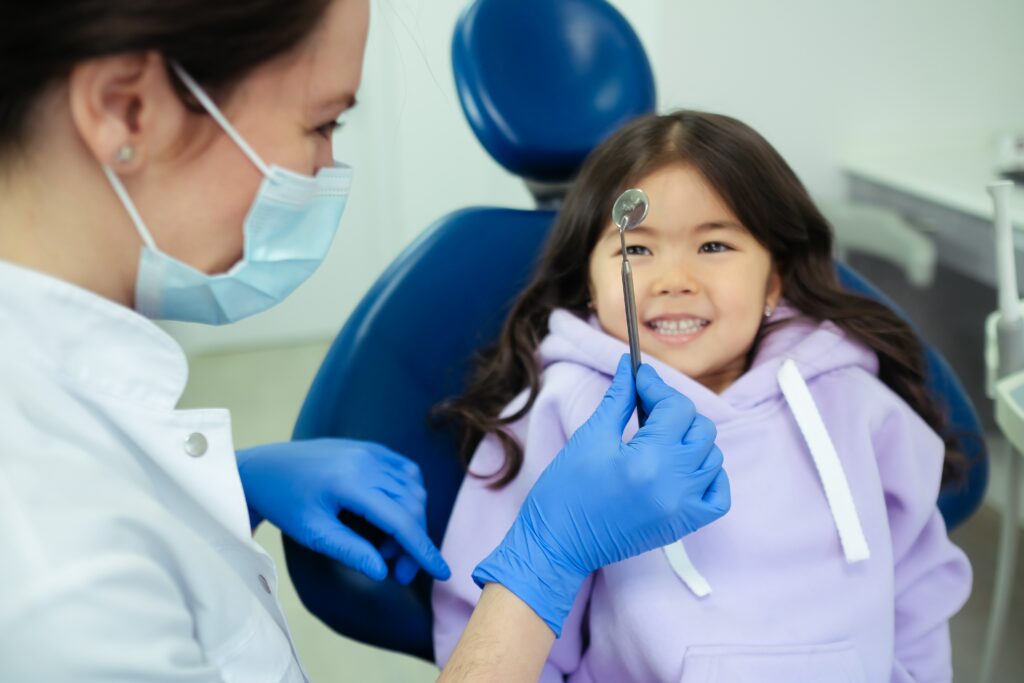 Dentist showing a dental tool to child