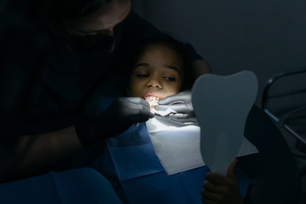 Dentist doing dental treatment to a child.
