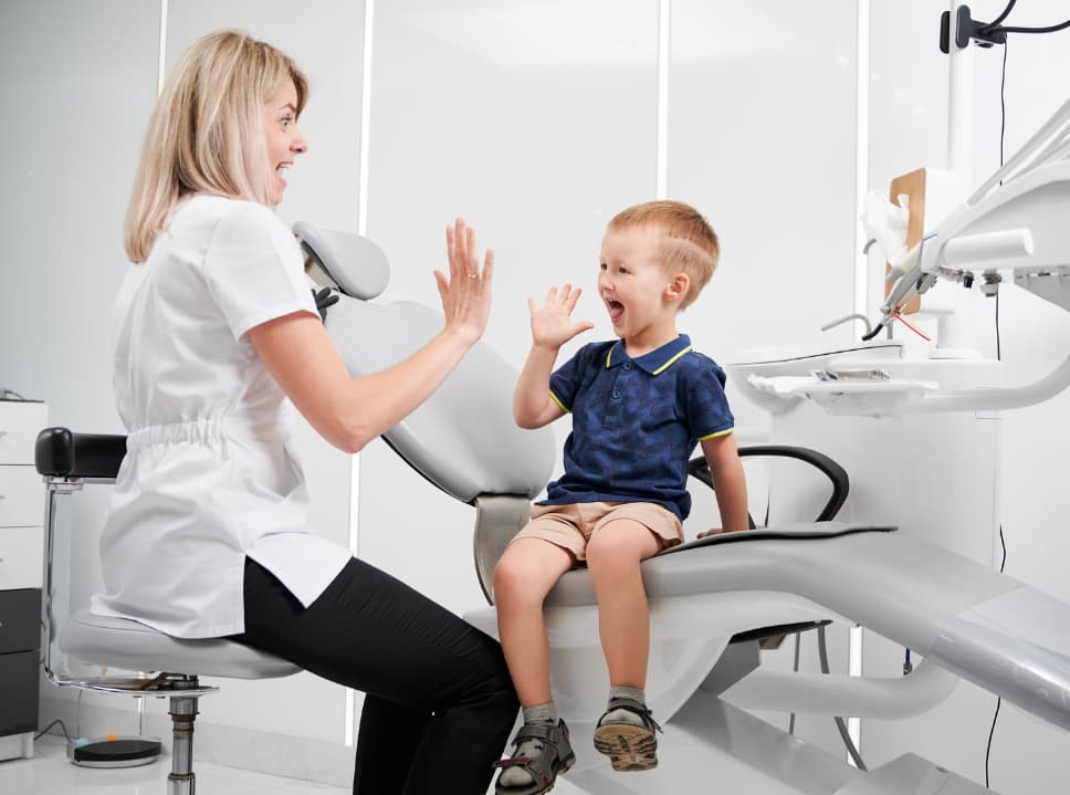 A dentist giving a kid patient a high-five