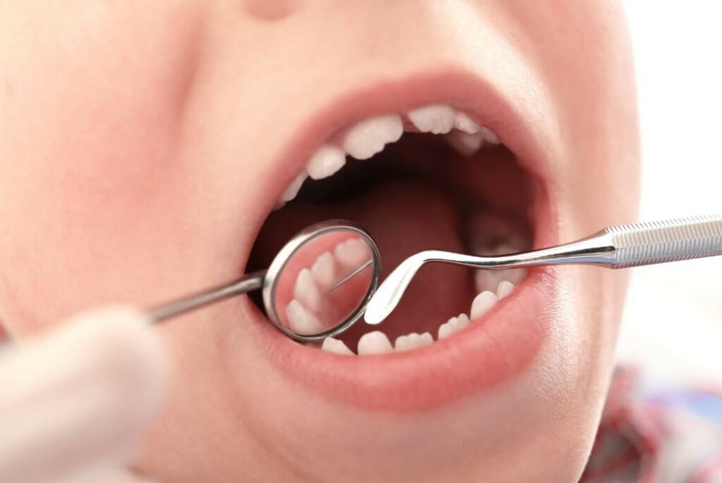 A dentist examining a boy's teeth