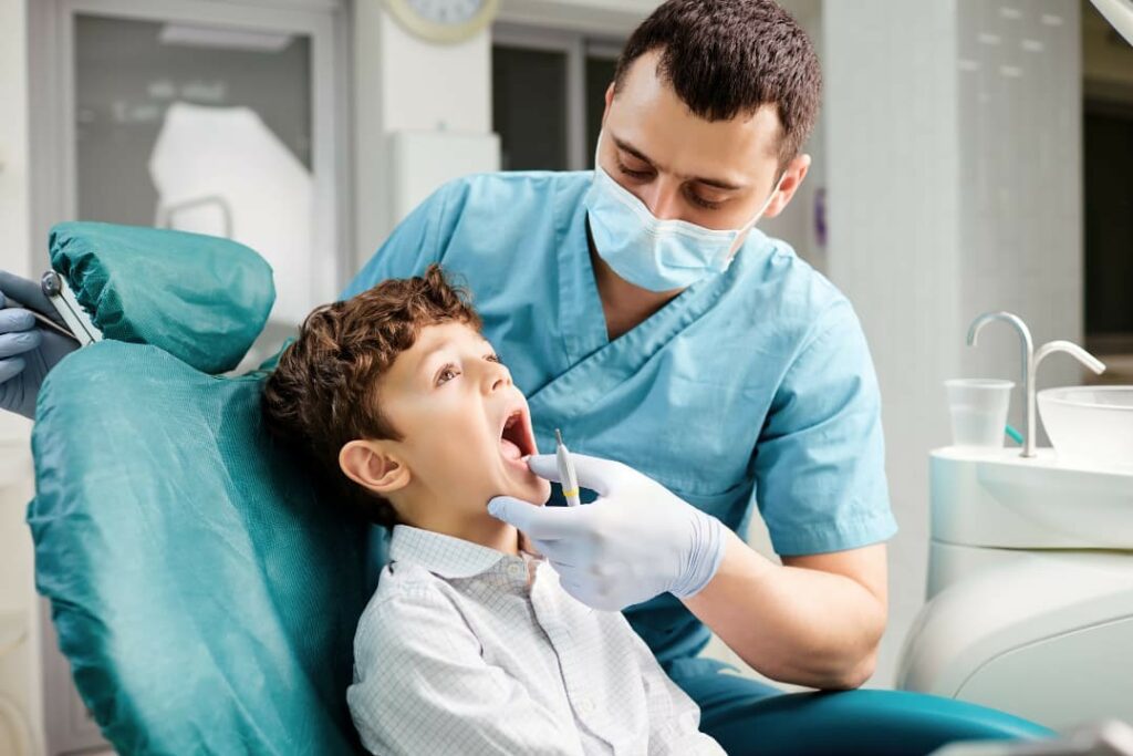 A male doctor checking a child’s tongue