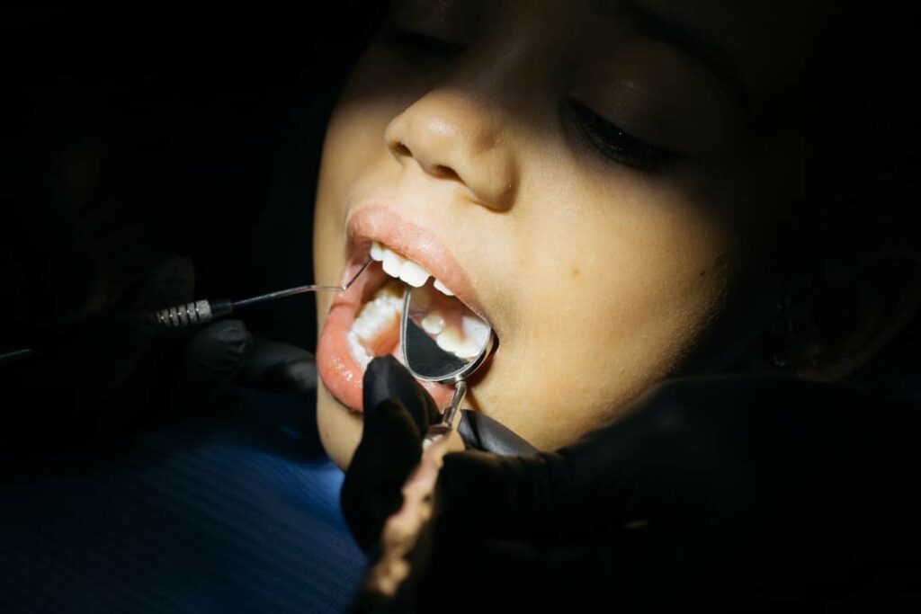 A child having her teeth checked for baby bottle tooth decay at the dentist
